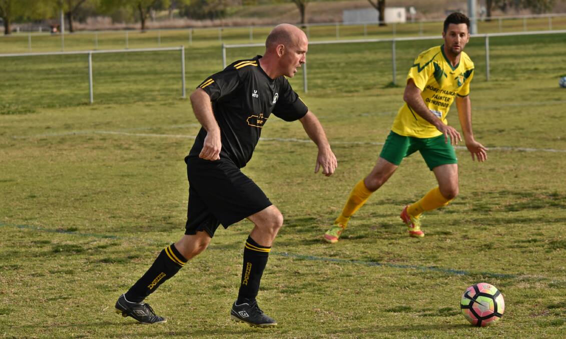 HIGH HOPES: Andy Cygan whips a cross in for Gunnedah FC in last year's grand final against Souths United. Photo: Ben Jaffrey