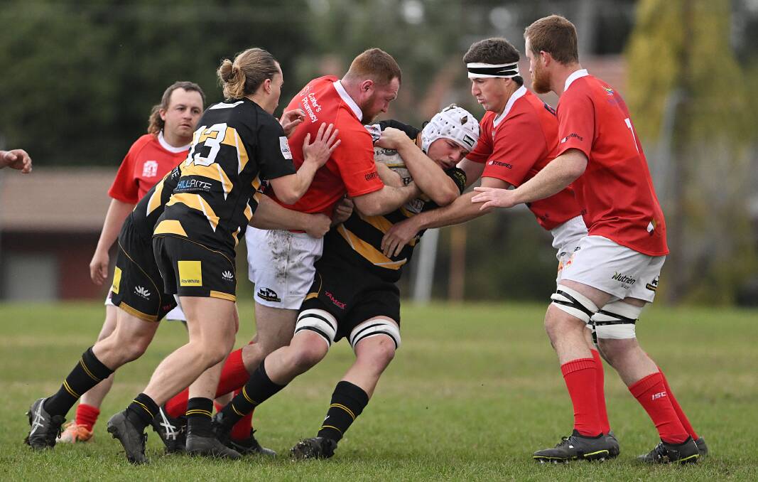 Pirates second rower Mitch Mack is wrapped up by NIck Lyons and Tim McDermott. Picture by Gareth Gardner
